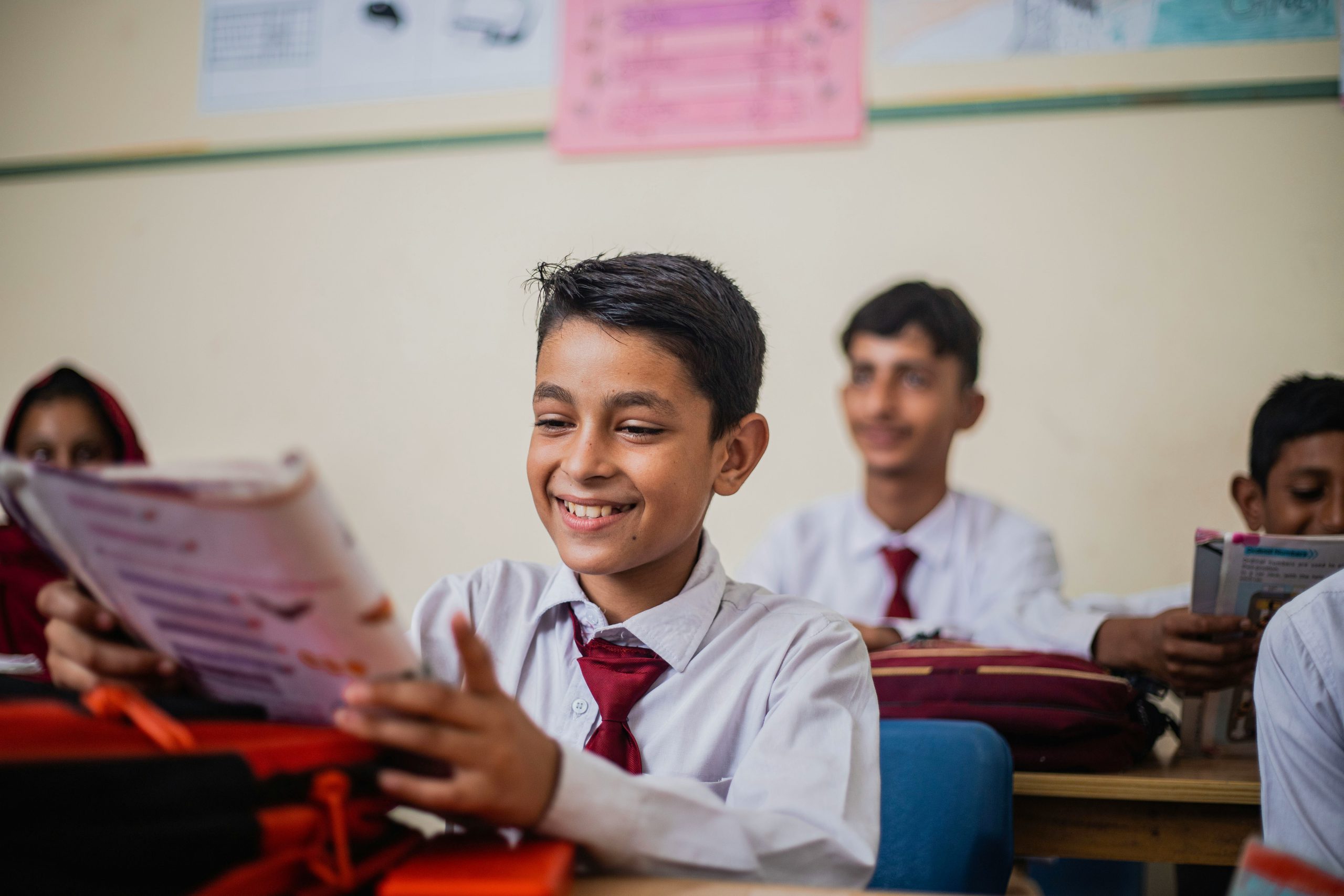 Young student reading in a classroom